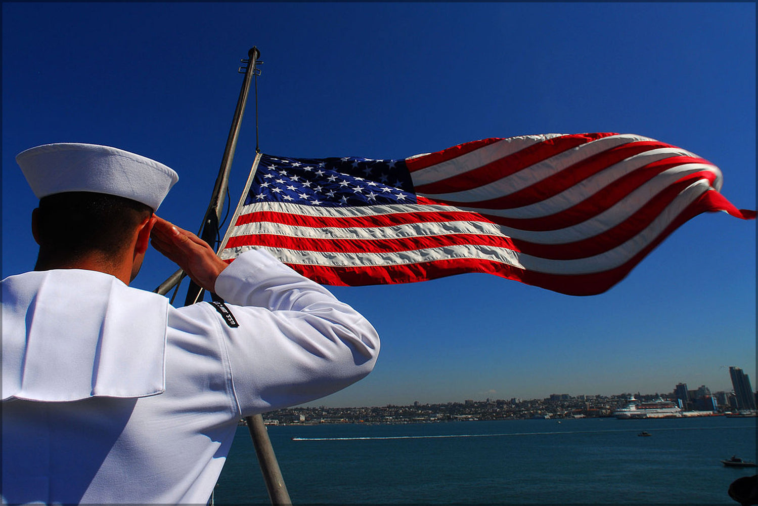 24"x36" Gallery Poster, Airman salutes flag onboard  carrier USS John C. Stennis (CVN-74)