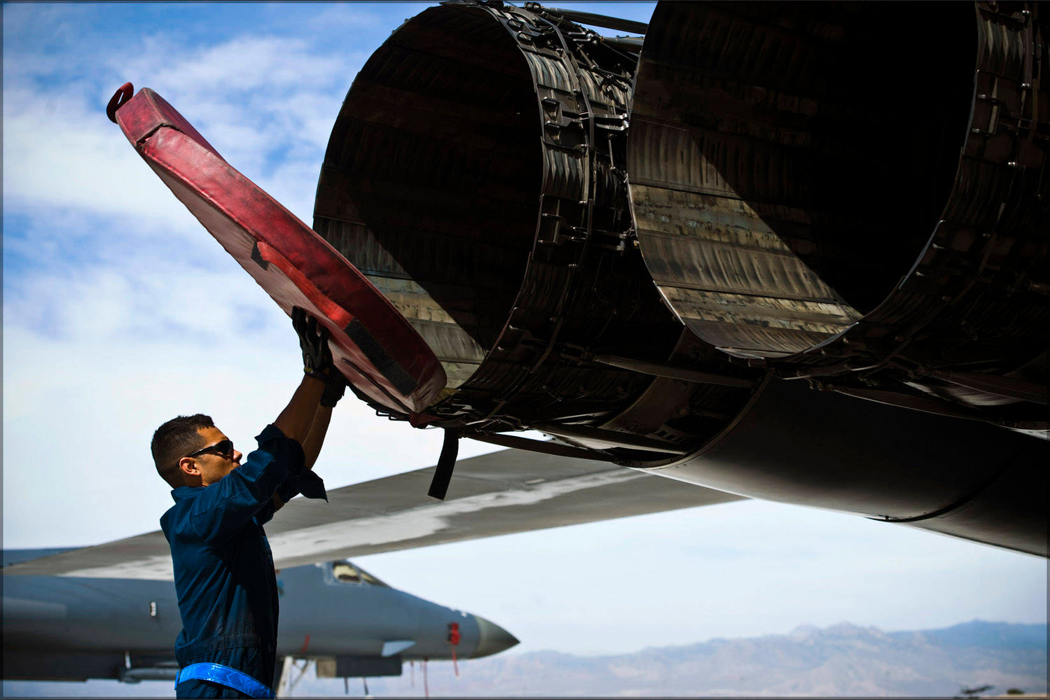 Poster, Many Sizes Available; Crew Chief Removes Exhaust Covers From A B-1B Lancer Bomber