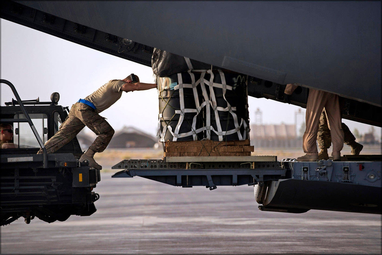 Poster, Many Sizes Available; A U.S. Air Force Airman Pushes A Pallet Of Cargo Into A C 17A Globemaster Iii At Kandahar Airfield In Afghanis